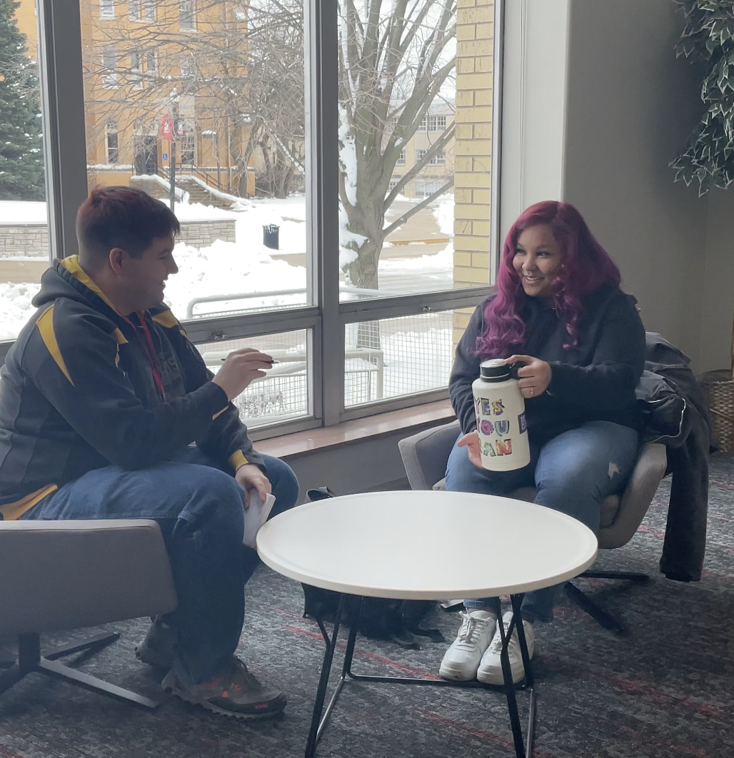 Video Editor Joseph Howerton (left) asks Meika Bass, a freshman computer science major, about the best brands of water bottles. Which water bottle brand is best? (Quentin Brown | Northern Star)